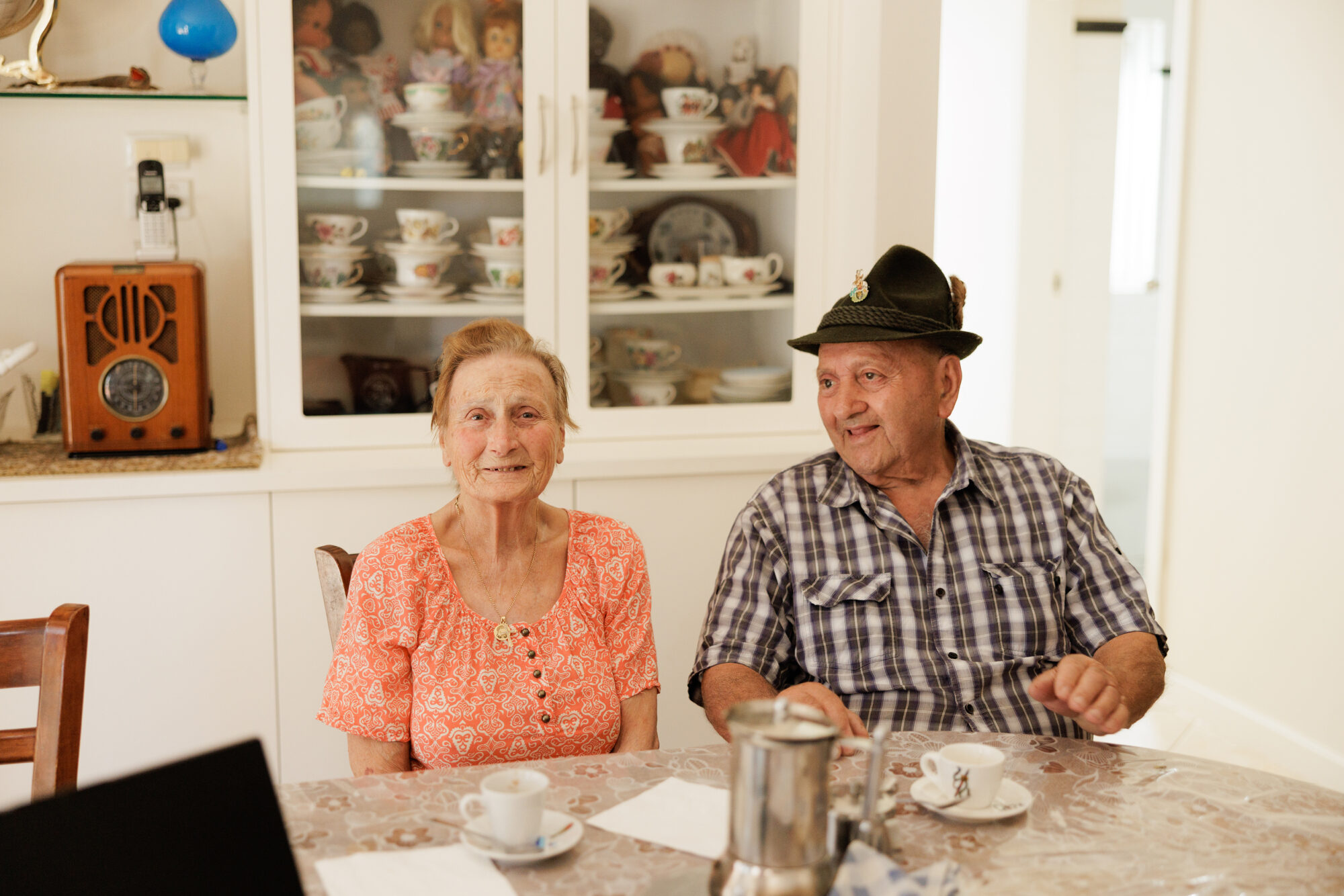 An older couple sitting together at home.
