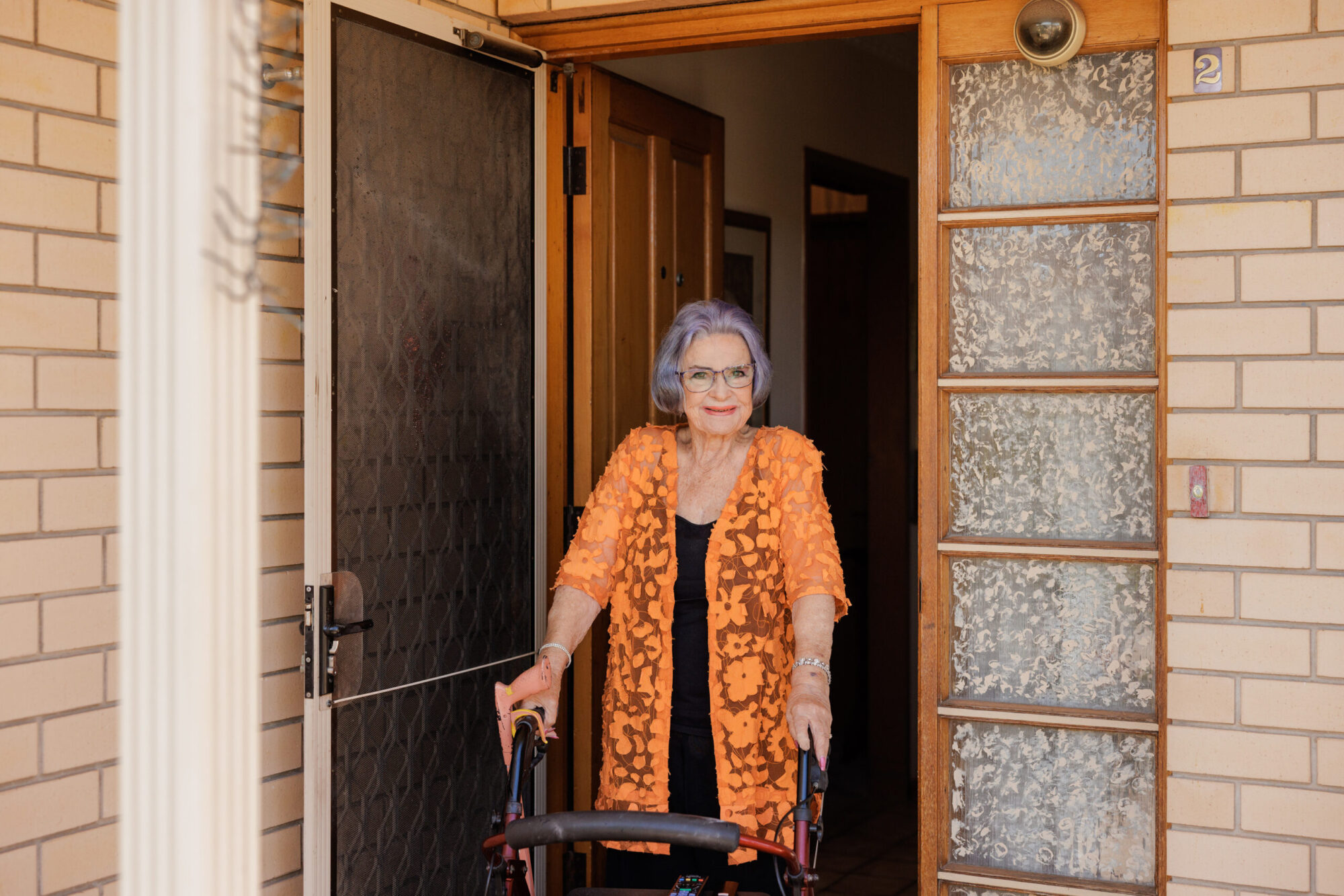 A care home resident smiling warmly.