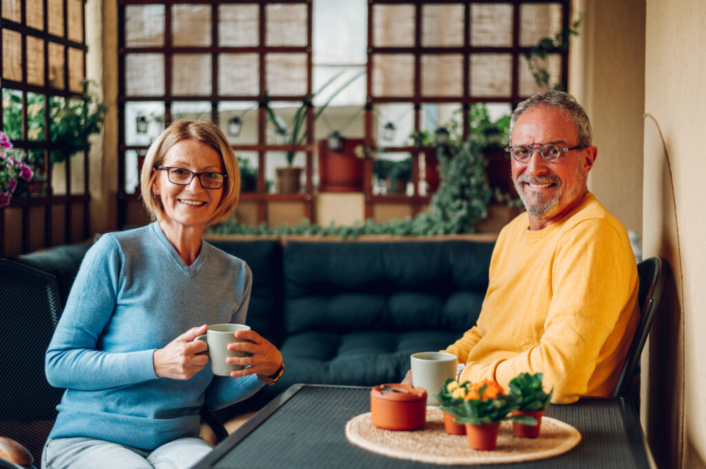 A wife sitting close to her husband, a care home resident.